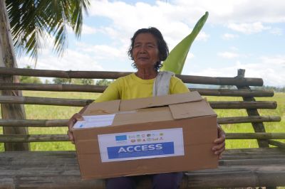 A bling woman is holding a box of humanitarian aid 