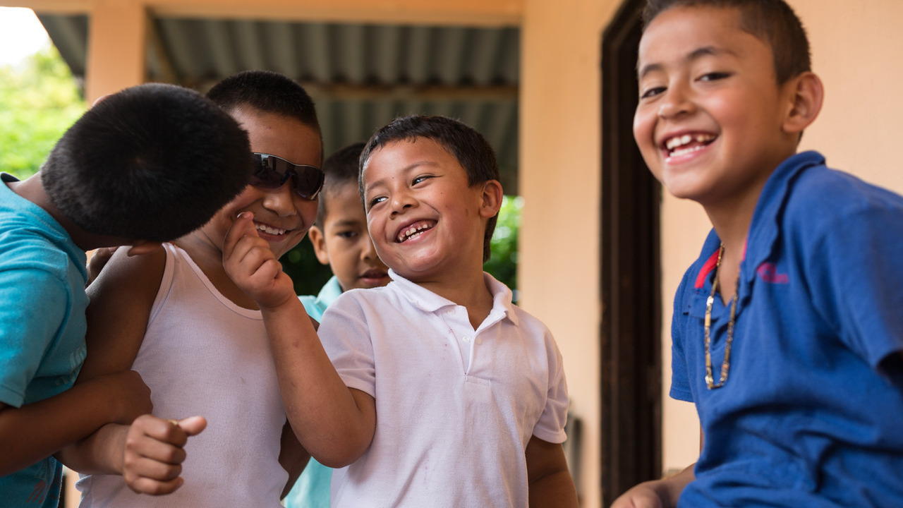 Close-ups of young children laughing.