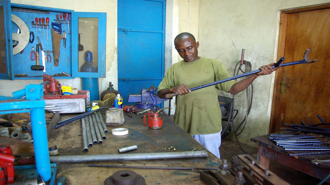 A man building a crutch in a workshop.