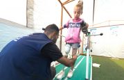 Malak is pictured at the HI prosthetics and orthotics center during a physical therapy session. She is learning how to walk with her artificial leg.