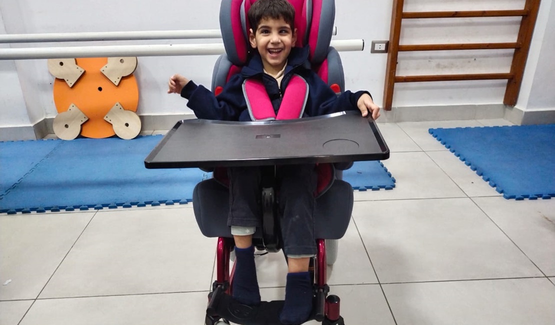 Mohammed in his new wheelchair, adapted to his disability. 