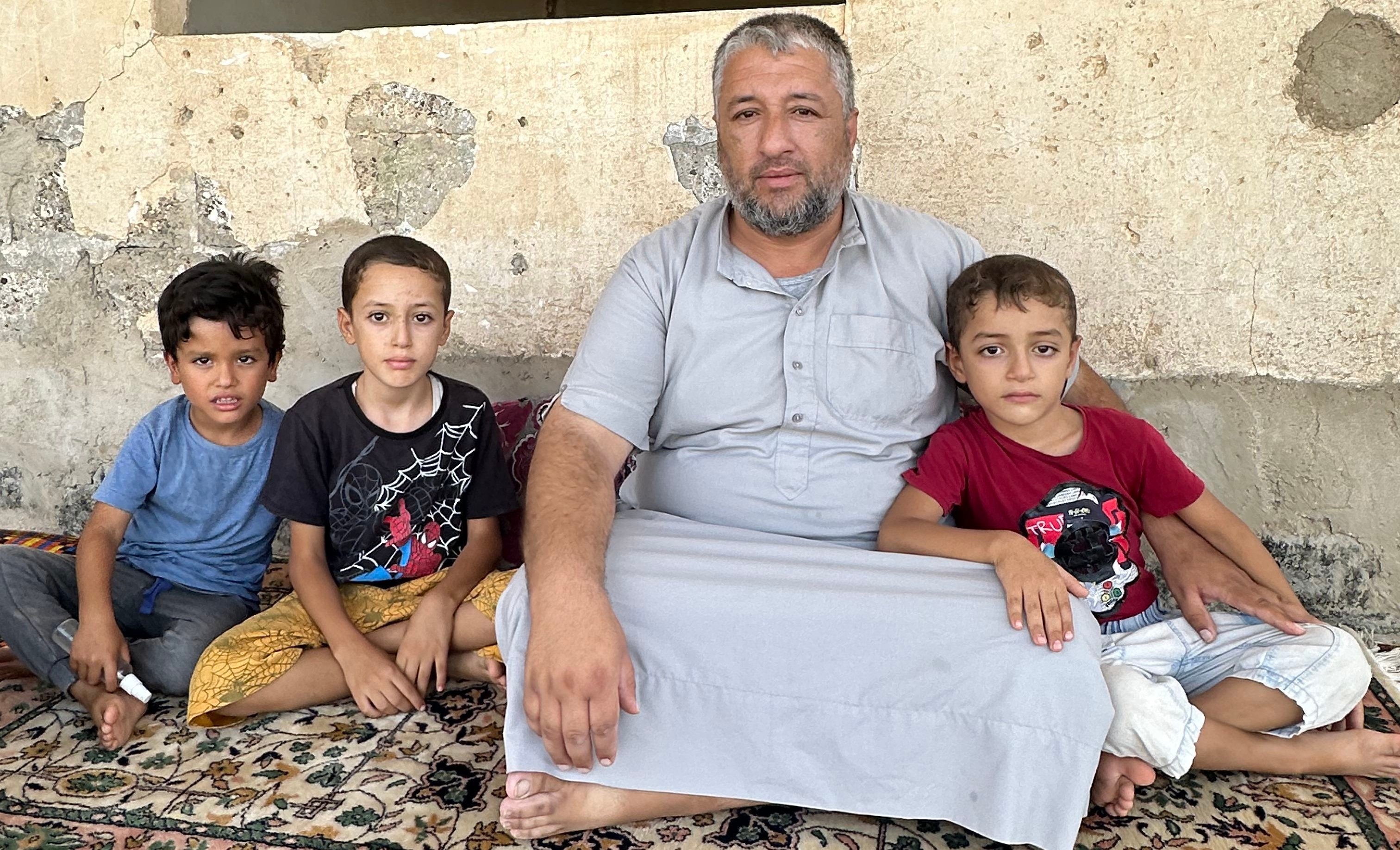 Qais at his home with his chidren  Qais at his home with his chidren