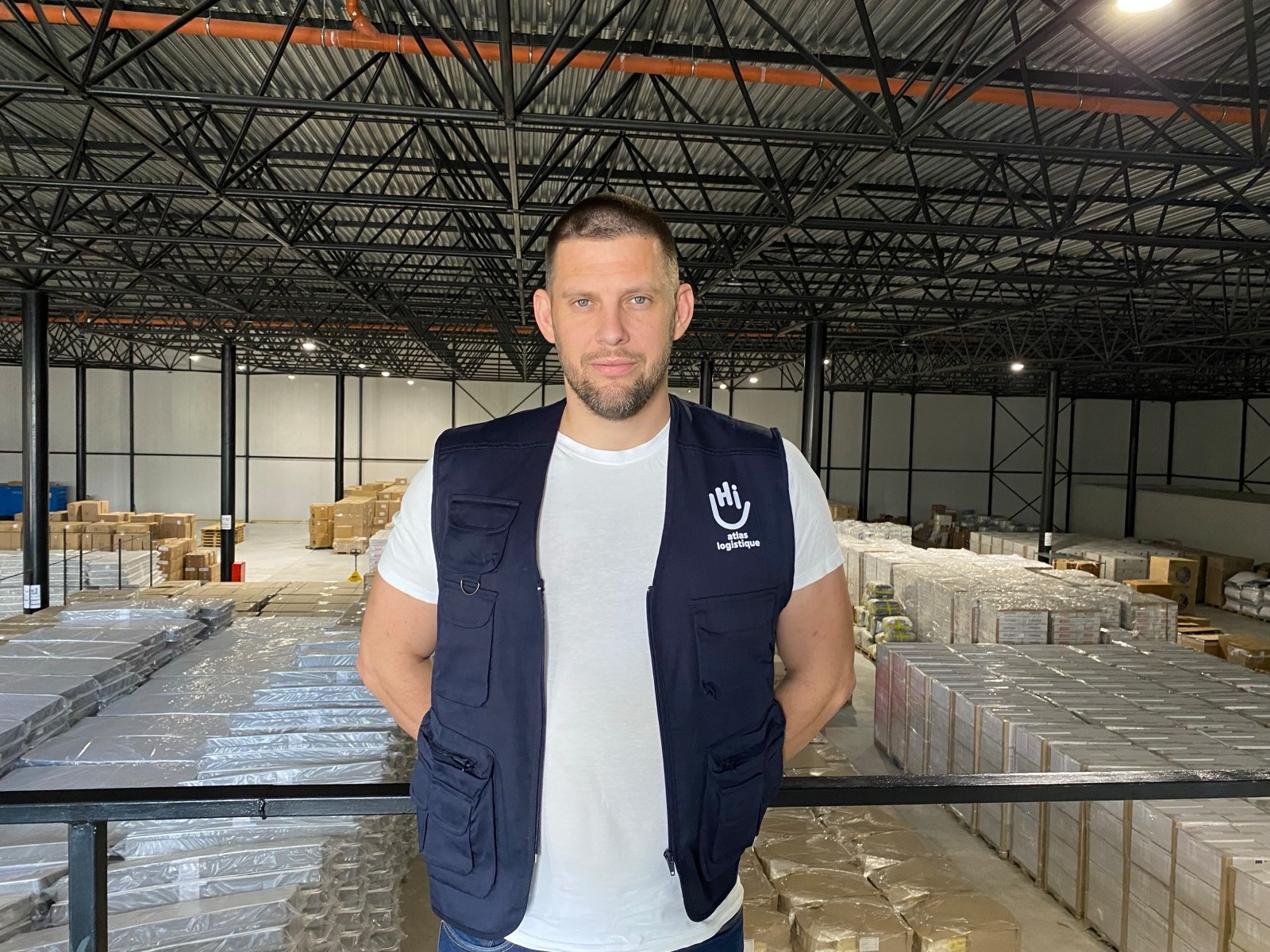 Vitalii Rabcheniuk, Atlas Logistics Project Manager, stands in a warehouse in Ukraine. 